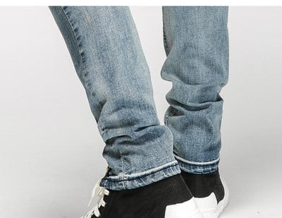 DISTRESSED ANKLE ZIP JEANS