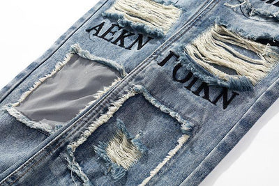 DISTRESSED GRAFFITI JEANS